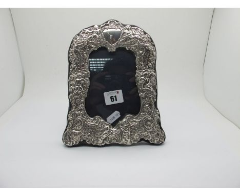 A Hallmarked Silver Mounted Photograph Frame, KFLd, London 1991, of antique style, detailed in relief, on plush easel back, 2