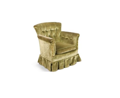 A button back armchair by Howard &amp; Sons Ltd,  upholstered in a button back green velvet raised on turned front legs with 