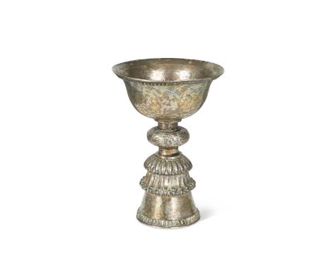 A Tibetan silver votive butter lamp, 18th/19th century, the ogee bowl is engraved with three panels of Buddhist precious obje