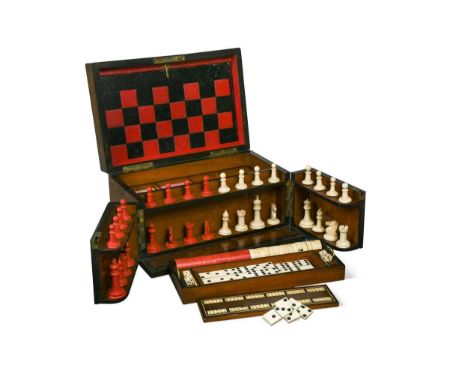 A Victorian walnut games compendium,  the foldout front with bone chess pieces, hinged top with two lift-out trays of playing