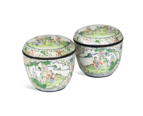 A pair of Chinese Canton enamel jars and covers, 20th century, painted with figures in garden settings in panels against foli