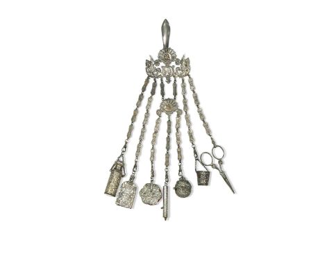A continental silver plated chatelaine, 19th century, with seven suspended items including a scent bottle, pin cushion and pr
