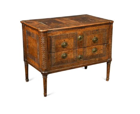 An Italian walnut commode, late 18th century, the moulded eared top crossbanded with panels over two drawers raised on fluted