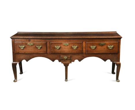 An oak and elm dresser base, 18th century,  the rectangular moulded top above three drawers over one smaller drawer with a sh