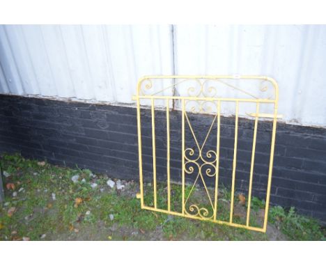 A yellow painted metal gate