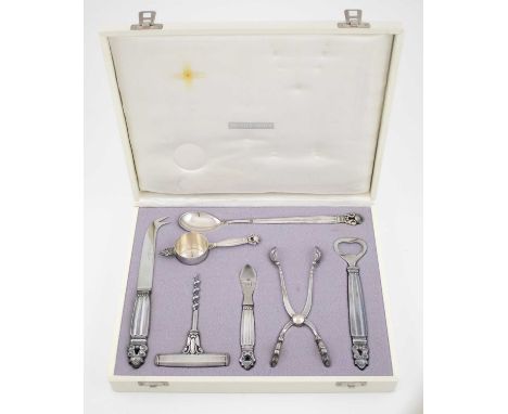 By Johan Rohde for Georg Jensen, a Danish silver Acorn pattern cocktail set, comprising: a bottle opener, a pair of ice tongs