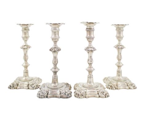 A set of four George II silver candlesticks,by John Cafe, London 1753,knopped baluster columns with foliate shoulders, spool-