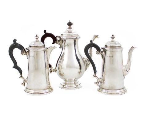 A pair of silver café au lait pots,by Robert Pringle, London 1953,tapering circular form, leaf-capped spout, scroll handle, h