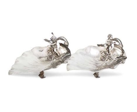 A pair of German silver figural dishes,by M. H. Wilkens and Son, Bremen circa 1900,leaf form, each mounted with a putto, one 