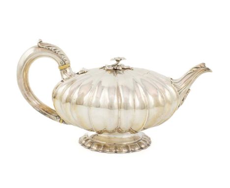 λ A William IV silver teapot, by Richard Sibley II, London 1835, lobed circular compressed form, flush hinged cover with a fl