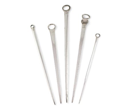 A collection of five antique silver meat skewers, various dates and makers, comprising: one with a shell and ring terminal, b