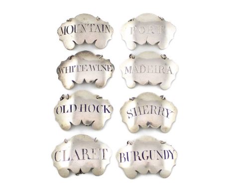 A matched set of eight George III silver wine labels,cartouche form, comprising: two by Margaret Binley, incised 'White Wine'