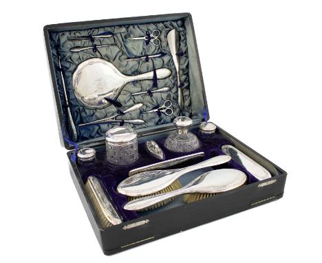 λ A matched silver cased dressing table set,by Charles S Green &amp; Co Ltd, Birmingham 1912 and 1913,threaded and floral bor