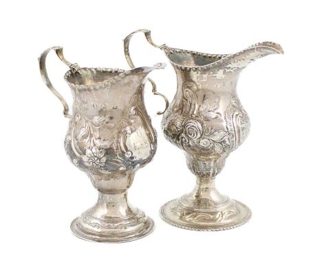 Two George III silver cream jugs, one by Thomas Shepard, London 1774, baluster form with punched beaded border, embossed foli