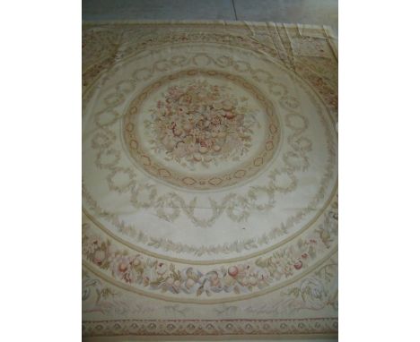 Large beige ground needle point woollen carpet with central circular repeating pattern and floral panel (315cm x 300cm) 