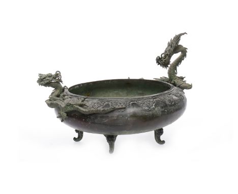 LATE 19TH/EARLY 20TH CENTURY CHINESE BRONZE BOWLmodelled with dragons in high relief and with tao tie masks around the rim, o