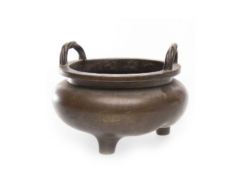 20TH CENTURY CHINESE BRONZE CENSERof circular bombe form, with twist effect handles, on three feet, mark to base, 10.5cm diam