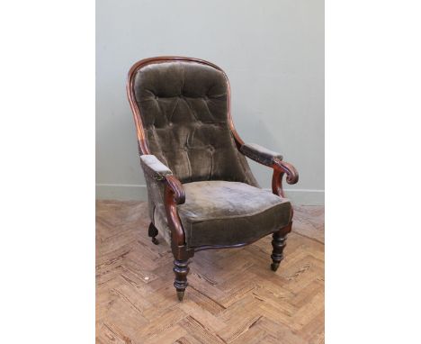 A Victorian carved walnut button back upholstered armchair
