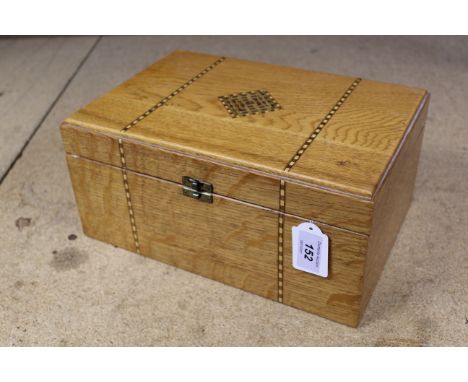 An inlaid oak sewing box with lift out shelf and vintage contents