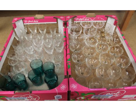 Two trays of drinking glasses including champagne saucers and blue glass whiskies