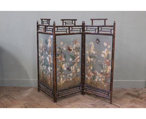 A late 19th Century three panel fire screen in bamboo frame with three pointed glass panels