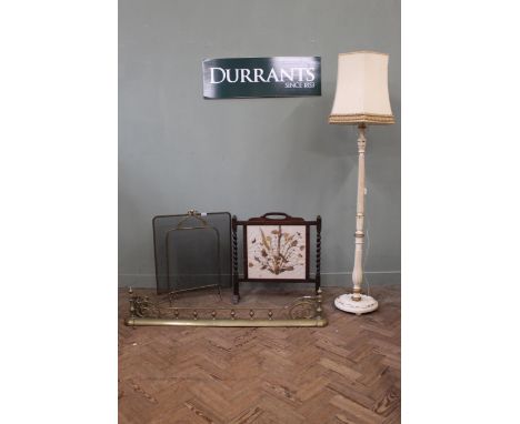 A brass fender, a brass fire guard, an oak barley twist fire guard and a painted standard lamp
