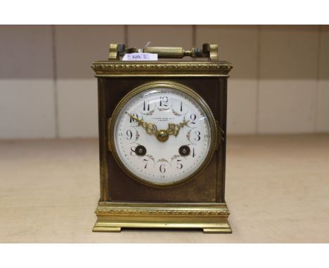 A vintage brass chiming carriage clock, the face marked Camerer Cuss &amp; Co. London, the movement marked France, enamel fac