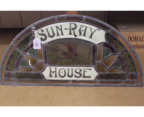 A stained glass fan light for Sun-Ray House with central bird panel