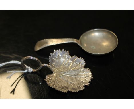 A HALLMARKED SILVER CADDY SPOON - BIRMINGHAM 1823, makers mark IT, together with another (2)