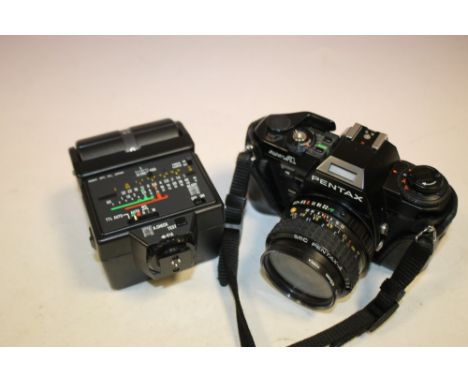A VINTAGE PENTAX CAMERA TOGETHER WITH A FLASH