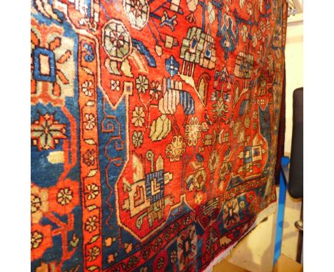A fine north west Persian Nahawand rug 245cm x 152cm central floral medallion with repeating spandrels on a terracotta field 