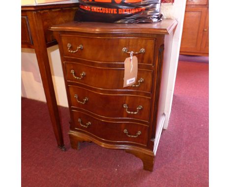 A Georgian style mahogany serpentine fronted chest fitted four drawers with brass handles on bracket feet