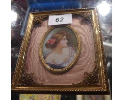 A portrait miniature of a lady, signed indistinctly and in a gilt metal frame
