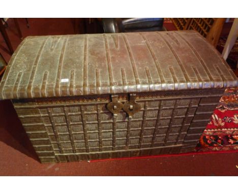 A large teak and iron clad dome top trunk with twin handles 