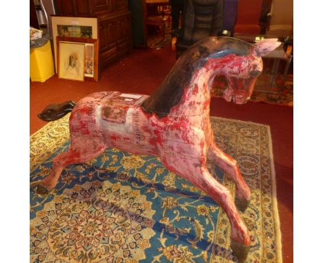 A vintage painted teak fairground horse 