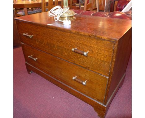 An Art Deco oak low chest fitted tow long drawers and raised on bracket feet