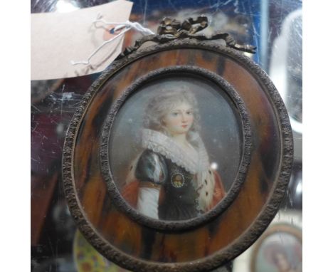 A portrait miniature of a young girl, signed Roi and in a brass and faux tortoiseshell frame 