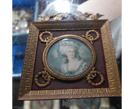 A portrait miniature of a lady, signed indistinctly and in a gilt metal frame