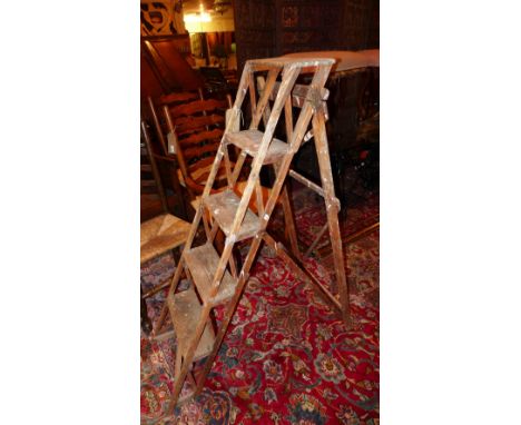 A weathered teak set of step ladders 