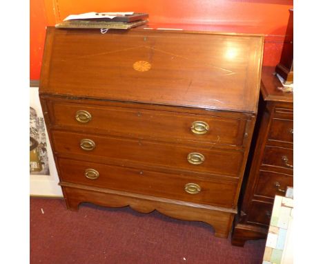 A 19th century mahogany and inlaid bureau, the fall front over three long drawers raised on bracket supports 