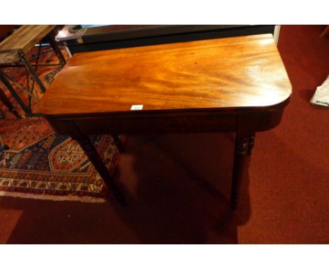 A 19th century mahogany card table, the foldover top raised on turned supports 