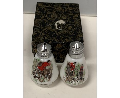A BOXED PAIR OF CERAMIC SALT AND PEPPER POTS WITH HUNTING SCENES 