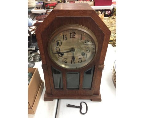 A WOODEN ARTS &amp; CRAFTS MANTLE CLOCK 