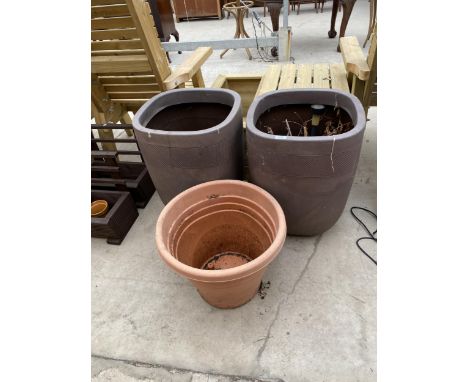 A PAIR OF BROWN PLASTIC GARDEN PLANTERS AND A FURTHER PLANTER 