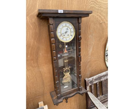 A DECORATIVE WOODEN CASED VIENNA WALL CLOCK 