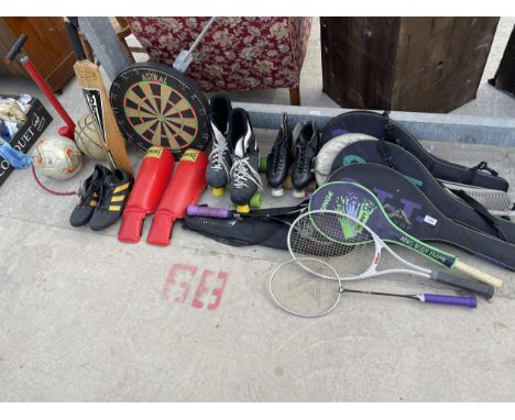 A LARGE QUANTITY OF SPORTS EQUIPMENT TO INCLUDE A DART BOARD, TENNIS RACKETS, ROLLER SKATES AND FOOTBALLS ETC 