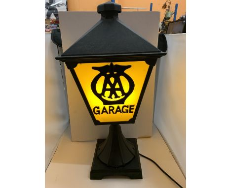 A CAST METAL LAMP WITH "AA GARAGE? THREE SIDED DETAIL TO PANELS AND BELIEVED IN WORKING ORDER BUT NO WARRANTY GIVEN 
