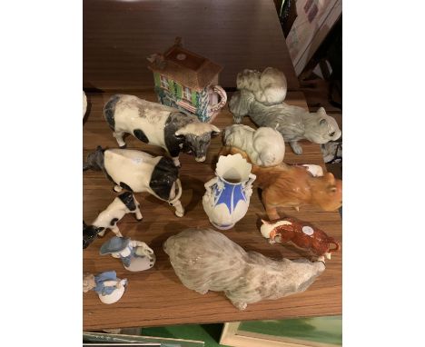 AN ASSORTMENT OF CERAMIC ANIMALS TO INCLUDE COWS, SQUIRRELS, BADGER, ALSO INCLUDES TWO FIGURES A VASE AND A VILLAGE COLLECTAB