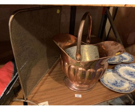 A COPPER COAL SCUTTLE, AN EMBOSSED BRASS PLANTER AND A FIRE GUARD 
