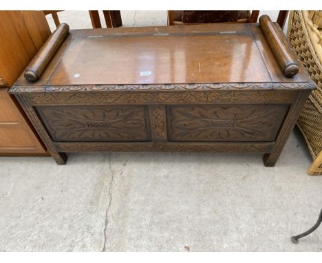 A 20TH CENTURY OAK VICTORIAN STYLE CARVED BLANKET CHEST/SEAT, WITH ROLLING PIN ARMS 42" WIDE 